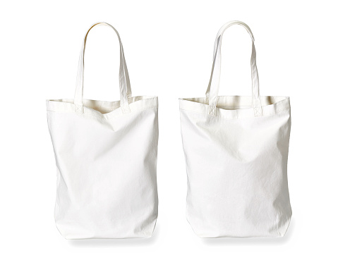 Two same sized white cotton bags on white background
