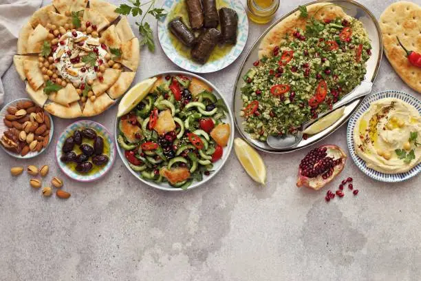 Traditional Lebanese dishes assortment. Chickpea Fatteh, Tabbouleh, Fattoush Salad, Hummus and various of appetizers. Flat layot, selective focus
