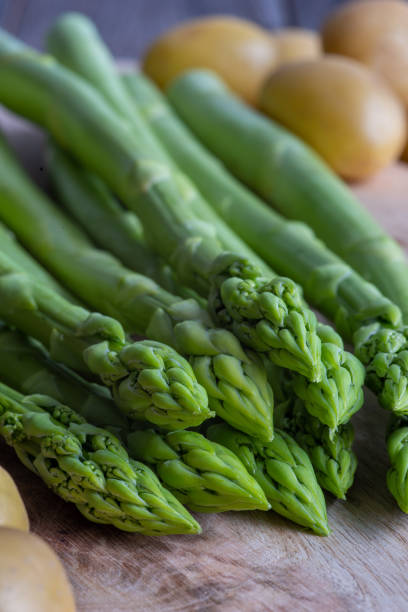 istock fresh green asparagus and potatoes, uncooked 1388995463