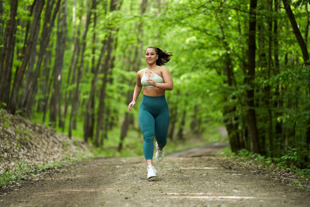 istock Plus size runner woman in the forest 1388996612