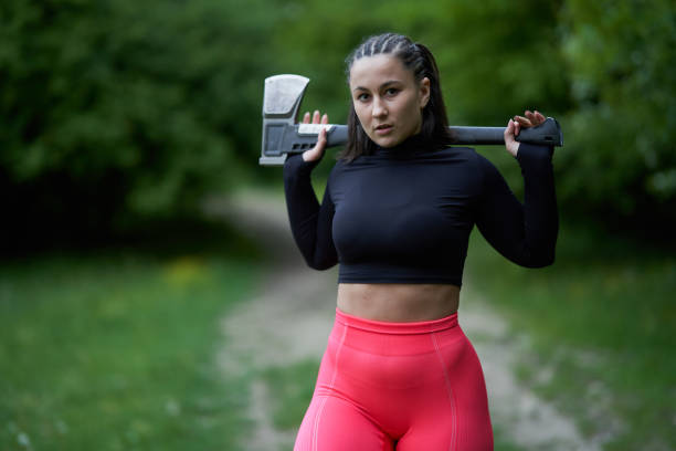 istock Young woman with heavy axe 1388996680