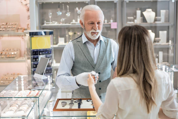 istock Young woman looking at a wristwatches 1388997791