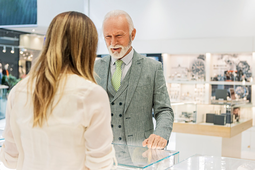 Senior man buying expensive wristwatch in jewelry store