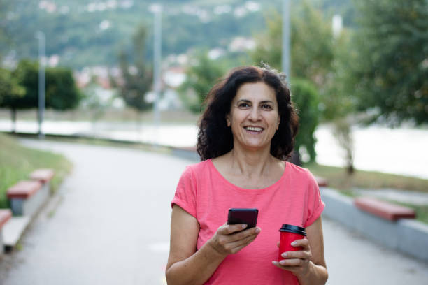 istock Senior woman usigg her smartphone 1389001880