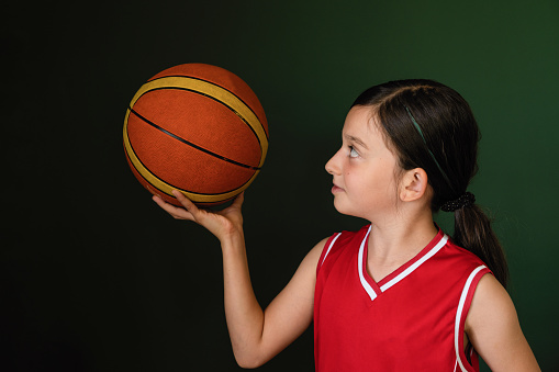 Portrait of cute teenage girl basketball player