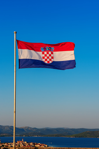 Croatia national flag waving in the wind on a deep blue sky. International relations concept.