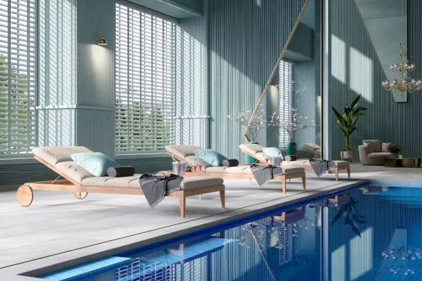 Luxury Hotel Indoor Swimming Pool With Close-up View Of Deck Chairs By The Pool