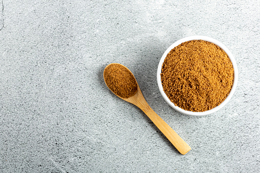 Brown sugar in ramekin on the table.