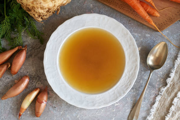 istock Homemade bone broth in a soup plate with carrots, onions and celery root 1389010482
