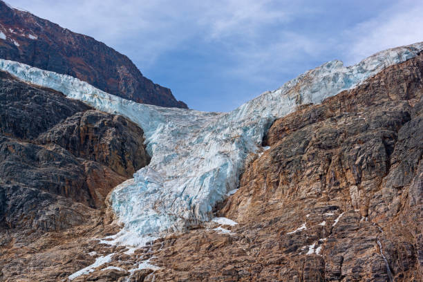 A Hanging Glacier Falling Off the Mountain Slopes stock photo