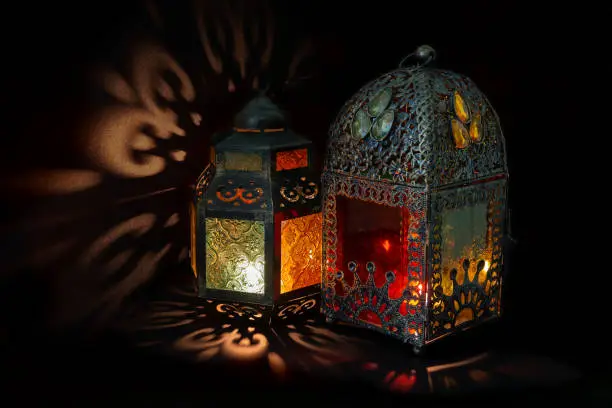 Photo of Two traditional Arabic lanterns lit up for celebrating the Holy Month of Ramadan