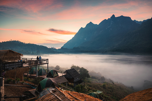 Scenic sunrise of Doi Luang Chiang Dao mountain and foggy in valley in traditional tribe village at Ban Na Lao Mai, Chiang Dao, Thailand