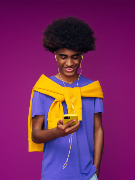 istock Portrait of funny afro guy using phone 1389015467