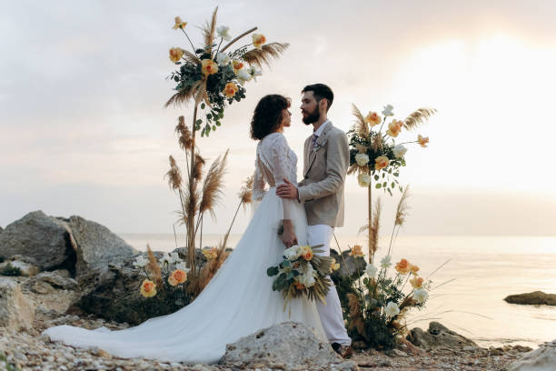 istock Wedding on the sunset with live floristry. Bride and groom in boho style. 1389015609