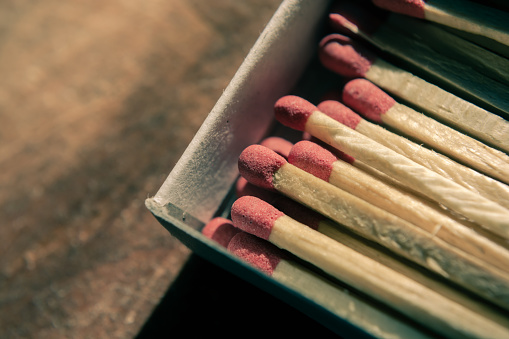 Red matches in a paper open box. Selective focus.