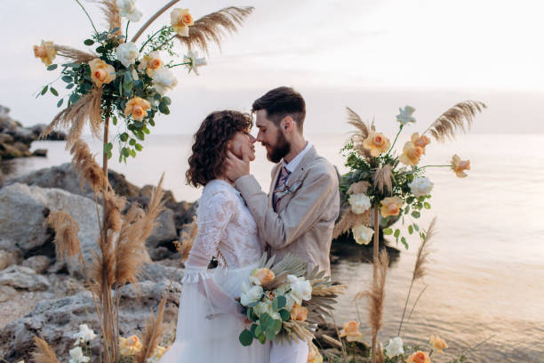 istock Wedding on the sunset with live floristry. Bride and groom in boho style. 1389016784