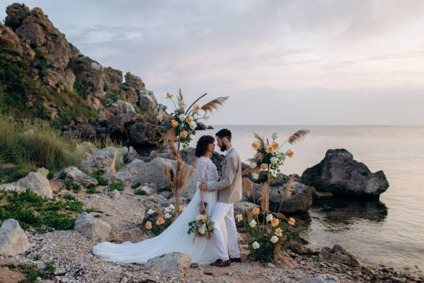 istock Wedding on the sunset with live floristry. Bride and groom in boho style. 1389016870