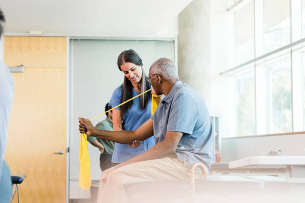 istock At therapy, senior man learns to use resistance band 1389017436