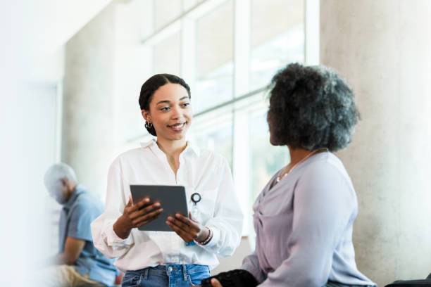 istock Therapist uses digital tablet to document patient answers 1389017446