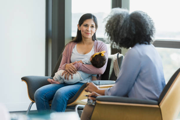 istock Mother sits and smiles at unrecognizable woman 1389017551