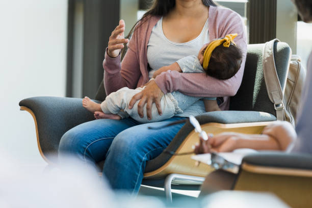 istock Unrecognizable human holding baby while gesturing to someone 1389017558