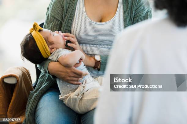 Unrecognizable Person Rocks Baby To Sleep Stock Photo - Download Image Now - Postpartum Depression, Postpartum Period, Support