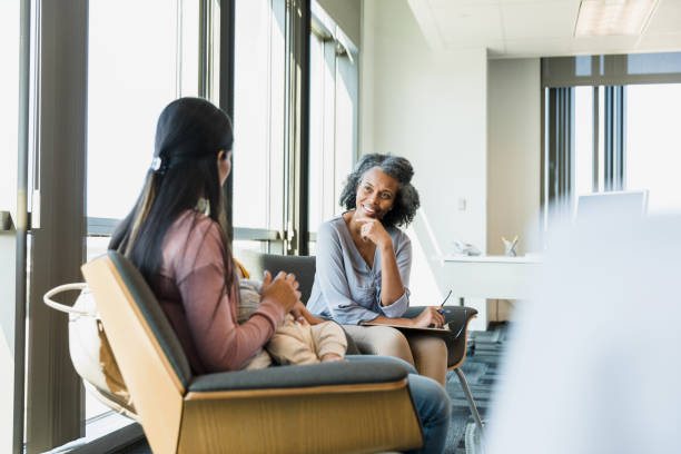 istock Two women sitting face to face in an office 1389017581