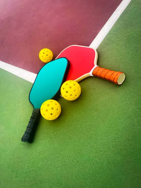 Photo of Pickleball Paddles and Balls on a court