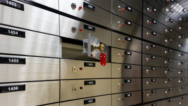 istock Safe deposit boxes inside bank vault. Open deposit box with key 1389022631