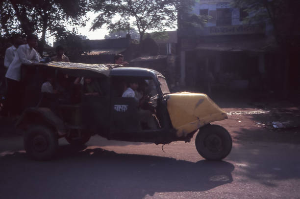 Uttar Pradesh, India - aug 11, 1996:   a very old three-wheeler travels the road of India .   Vintage photo. Historical archive photo.