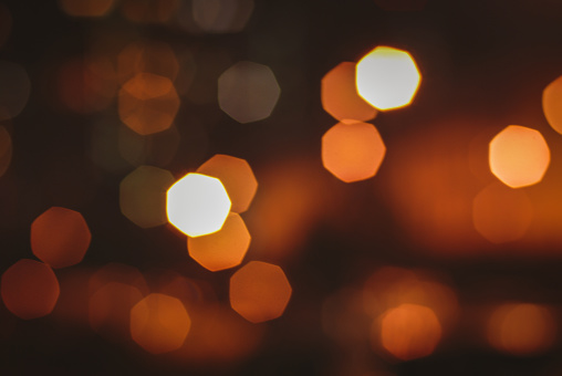 Blurry street lights at night, abstract background of bokeh warm light