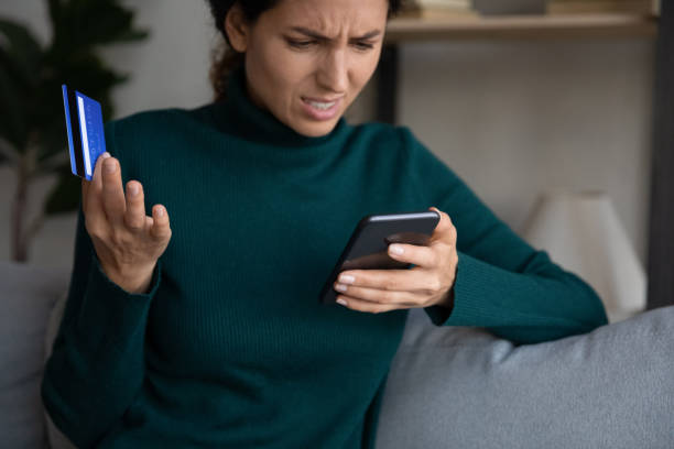 istock Unhappy Hispanic woman confused with problems paying online 1389032669