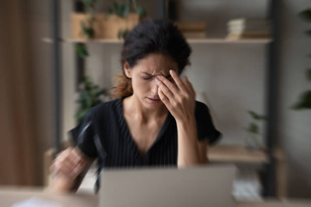 istock Sick Hispanic woman suffer from dizziness working on laptop 1389032686