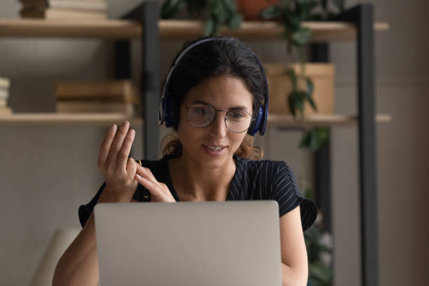 istock Hispanic woman talk on webcam call on laptop 1389032695