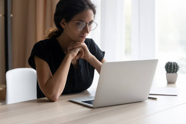 istock Young Latino woman work on computer online at home 1389032735