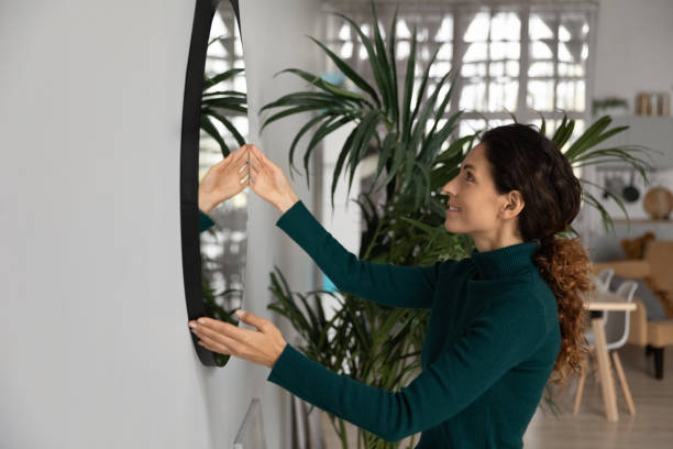 istock Happy Hispanic woman decorate home moving in 1389033521