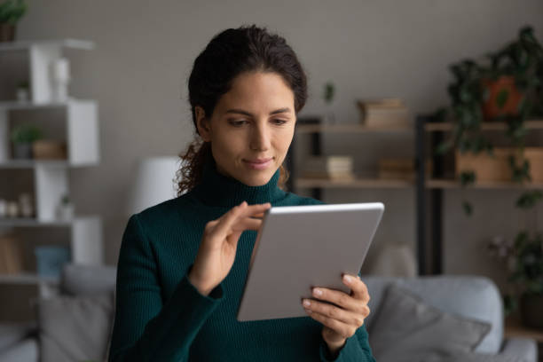 istock Latino woman use tablet browsing wireless internet 1389033533