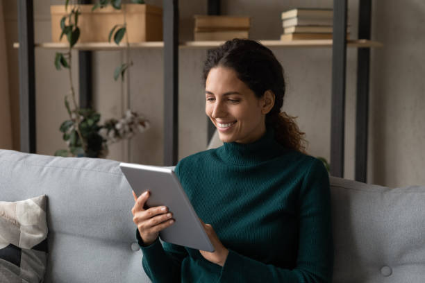 istock Smiling Hispanic woman use tablet shopping online 1389033566