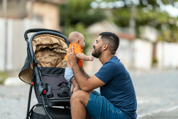 istock Father playing with baby in stroller 1389034303