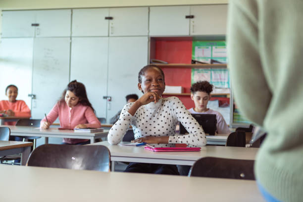 istock Attentive adolescent students listening to lecture in class 1389037722