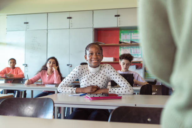 istock Attentive adolescent students listening to lecture in class 1389037810