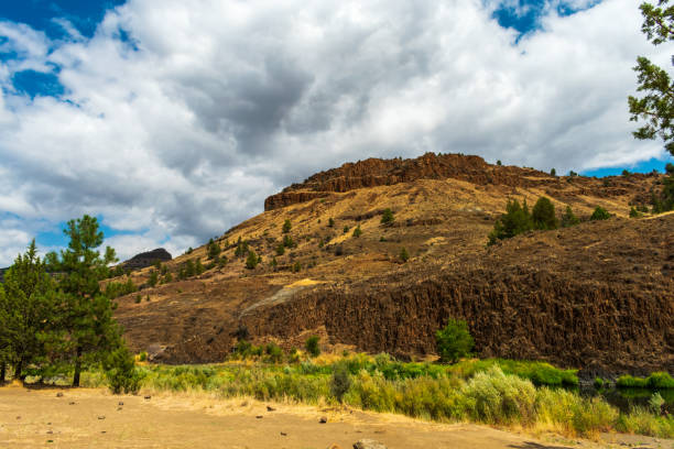 A quiet river in central Oregon runs along a cliff face, Oregon, USA