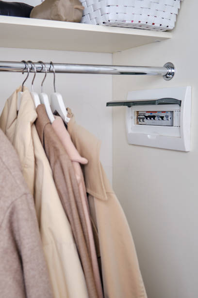 istock Automatic fusein a home electrical panel in the closet with clothes. Electricity equipment in the apartment, living room in the wardrobe 1389038255