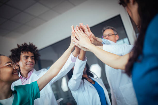 istock A multiracial group of doctors is celebrating a successful patient operation. 1389038323