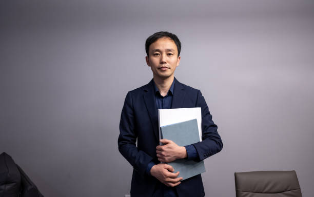 istock Holding documents in the office looking at the camera 1389051769