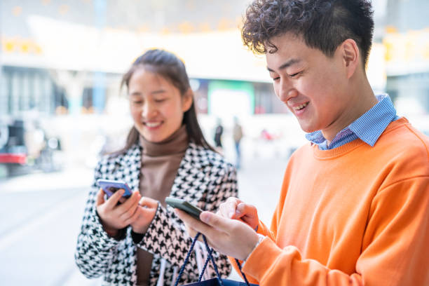 istock Asian young people using smartphone in city street 1389051945