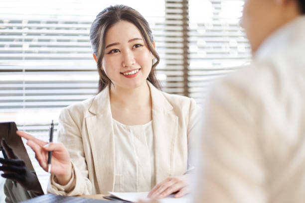istock Asian business woman explaining on a laptop 1389054473
