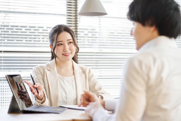 istock Asian business woman explaining on a laptop 1389054476