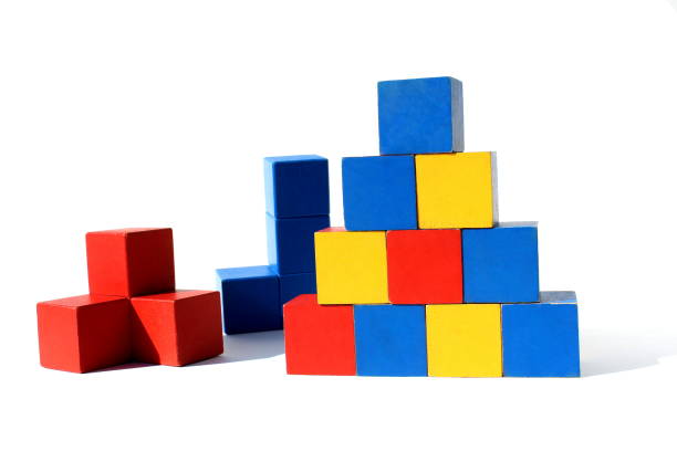 istock Children`s toy. Bright multi-colored cubes are stacked in a pyramid. 1389060086