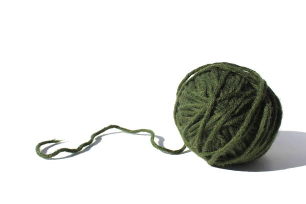 istock A ball of green woolen thread lies on a white background 1389060207
